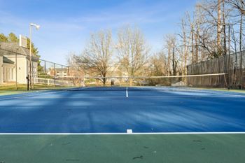 a tennis court with a fence around it on a sunny day at Ashton Creek, Virginia, 23831
